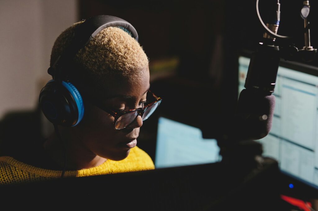 Focused black woman working in podcast studio